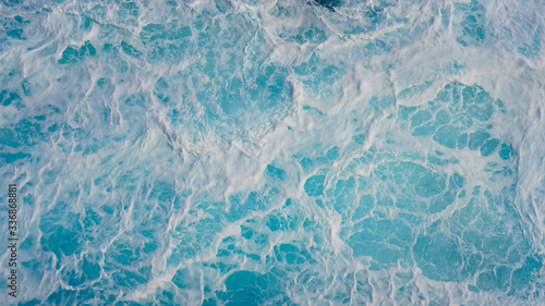 Abstraction of sea foam in the ocean. Turquoise light water.