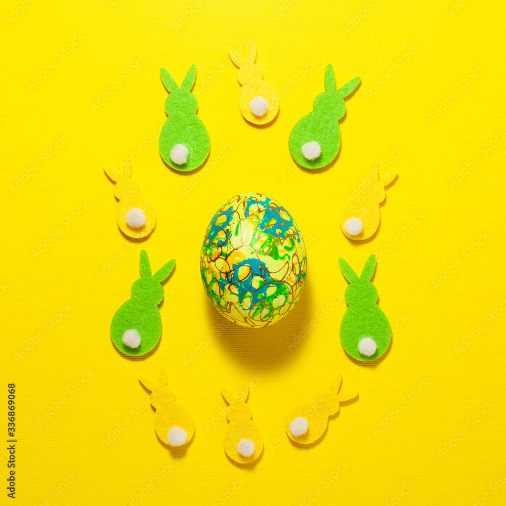 Easter green and yellow bunnies and egg flat lay