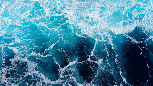 Abstraction of sea foam in the ocean. Dark water stormy waves turquoise pacific ocean water on a sunny day