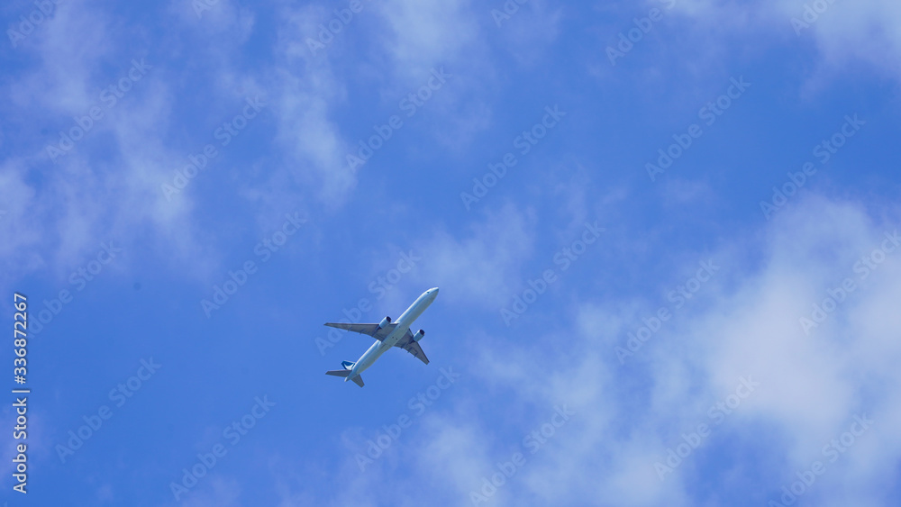 passenger plane on a background of blue sky. flying airliner comes in for a landing. plane in the deep sky with clouds