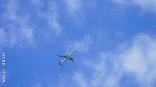 passenger plane on a background of blue sky. flying airliner comes in for a landing. plane in the deep sky with clouds