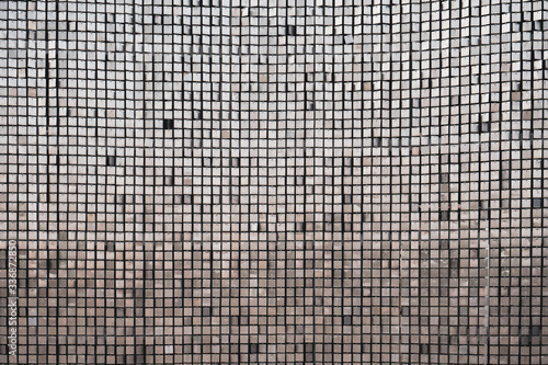 Silver metallic sheet square grid wall. background and surface for futuristic architecture.