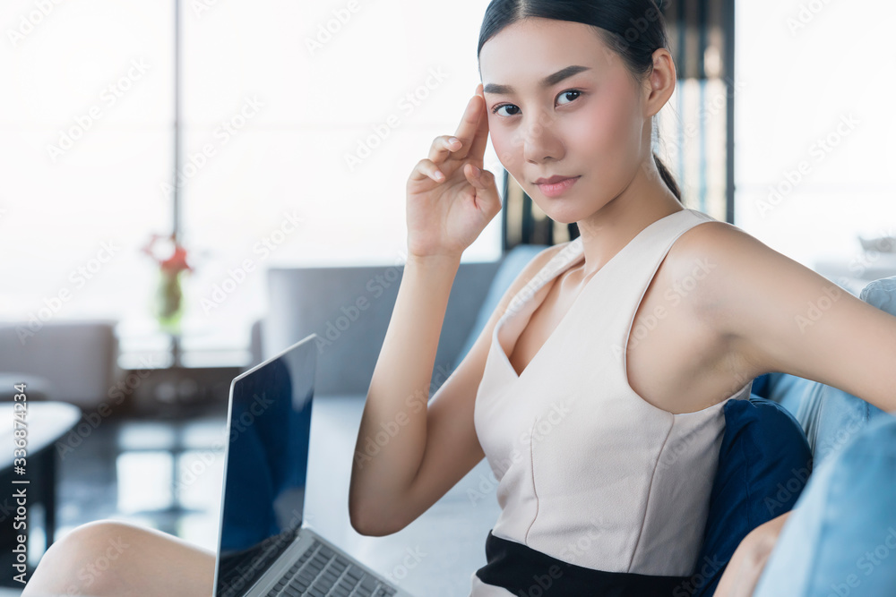 attractive beautiful asian female smart casual relax enjoy working from home socail distacing quarantine on sofa ,asian female happiness with private moment working on sofa home background attractive beautiful asian female smart casual relax enjoy working from home socail distacing quarantine on sofa ,asian female happiness with private moment working on sofa home background
