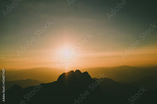 sunrise sky backlit with big mountain