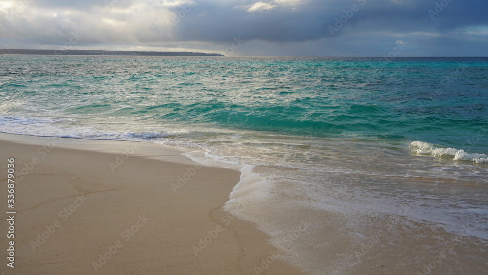 Incredible color ocean on a tropical island, clear blue turquoise water over a coral reef in the Pacific Ocean. sea wave on the golden sand of a tropical beach sunset sky Incredible color ocean on a tropical island, clear blue turquoise water over a coral reef in the Pacific Ocean. sea wave on the golden sand of a tropical beach sunset sky