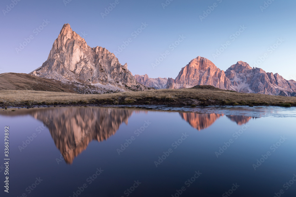 View of famous Dolomites mountain peaks glowing in beautiful golden morning light at sunrise in summer, South Tyrol,Italy
Ra Gusella and Giau pass reflection in lake.
Famous best alpine place in Alps.