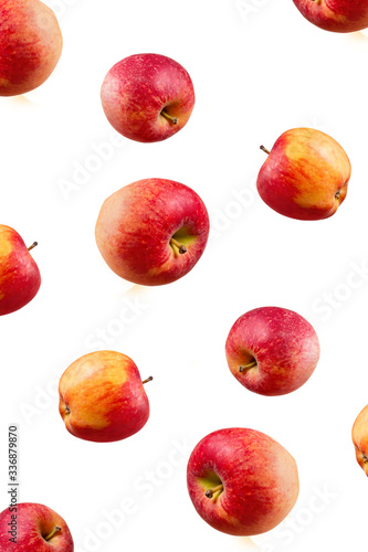 Large ripe red apples falling from top to bottom. Open composition. Close-up. Isolated on white background.