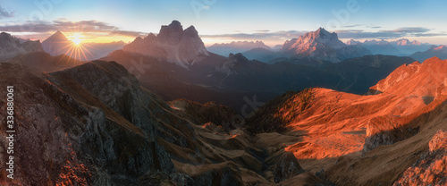View of famous Dolomites mountain peaks glowing in beautiful golden morning light at sunrise in summer, South Tyrol,Italy Monte Pelmo and Monte Civetta in sunny day. Famous best alpine place