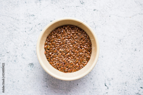Organic natural flax seeds in bowl.