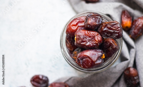 Date fruites, dates or sweet Iranian hurma in glass jar. Natural organic dieting dessert food. Vegan meal. Copy space. Top above view photo