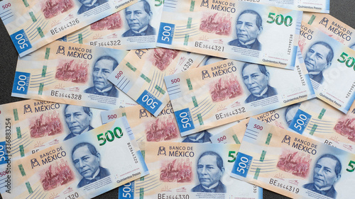 Mexican 500 pesos pile of blue bucks scattered front side