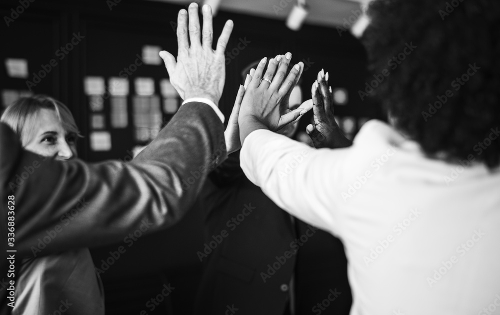 Business team giving a high five Business team giving a high five
