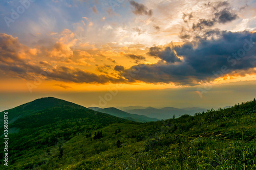 Beautiful landscape. Bright colorful sunset opening from the top of the mountain in the summer. Storm clouds during sunset. relax