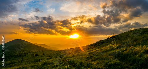 Beautiful landscape. Bright colorful sunset opening from the top of the mountain in the summer. Storm clouds during sunset. relax