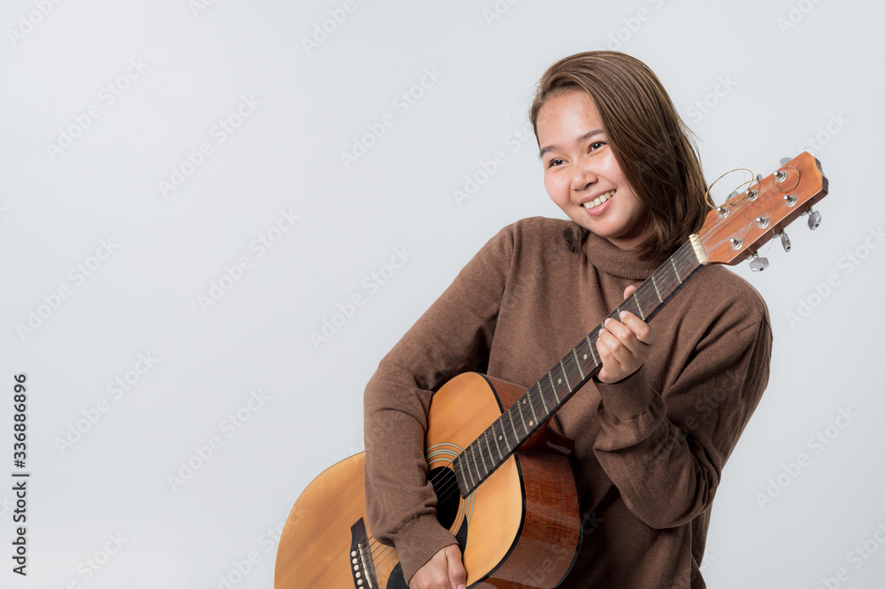 Fototapeta premium woman with guitar in studio shot on white background
