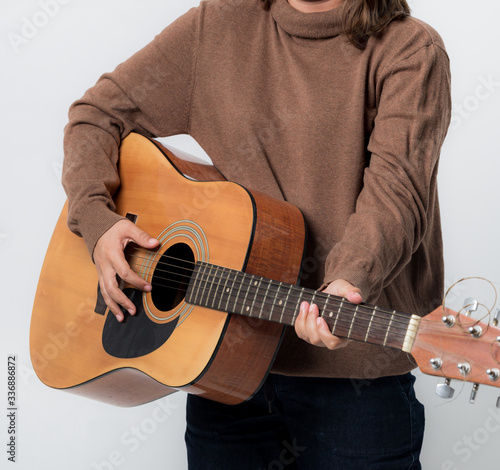 woman with guitar in studio shot on white background