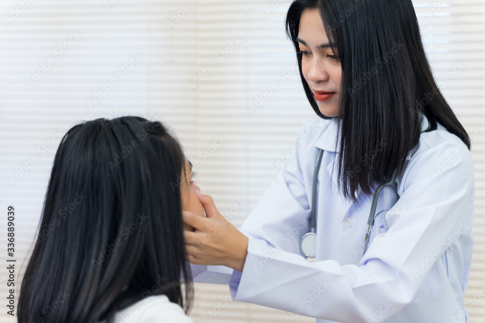 Young Asian female doctor checks an adult woman patient’s hand to examine and diagnose her sickness and symptom. Medicine and health care concept. Doctor and patient. Young Asian female doctor checks an adult woman patient’s hand to examine and diagnose her sickness and symptom. Medicine and health care concept. Doctor and patient.