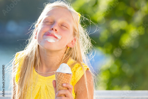Kid eating ice cream outdoors