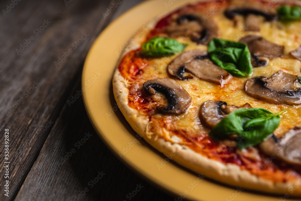 Freshly making pizza with mushrooms served on the rustic background. Selective focus. Shallow depth of field. Freshly making pizza with mushrooms served on the rustic background. Selective focus. Shallow depth of field.