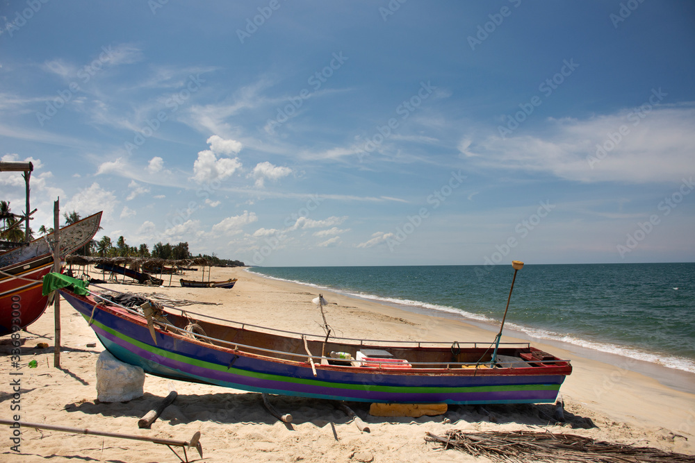 View landscape and wind with Kolek or Koleh traditional fishing boat of lower southern provinces of thai at Banton Beach in Narathiwat, Thailand