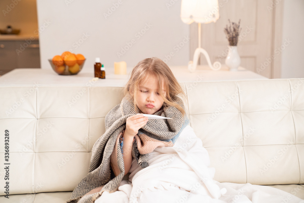 small girl in scarf sick, measures temperature. small girl in scarf sick, measures temperature.
