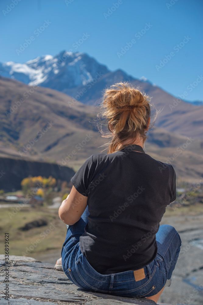 girl on the background of Mount Kazbek. North Ossetia .