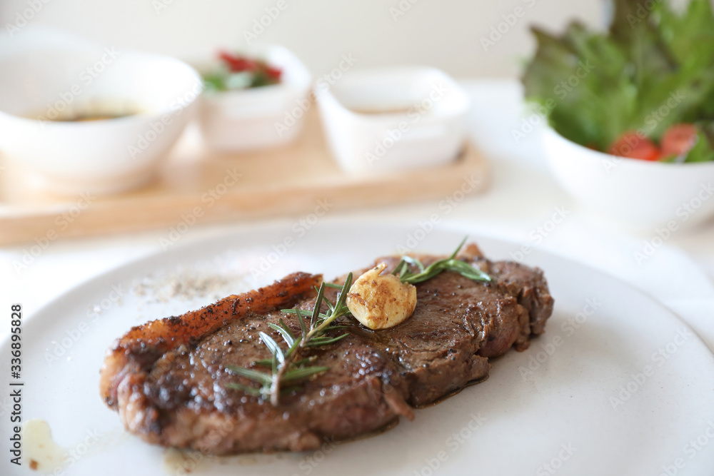 beef steak with salad on white table beef steak with salad on white table
