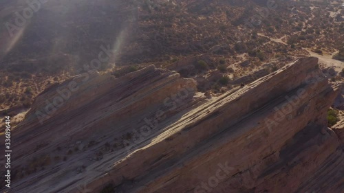 Cinematic 4K aerial video circling the Vasquez Rocks on a sunny afternoon with sun flare