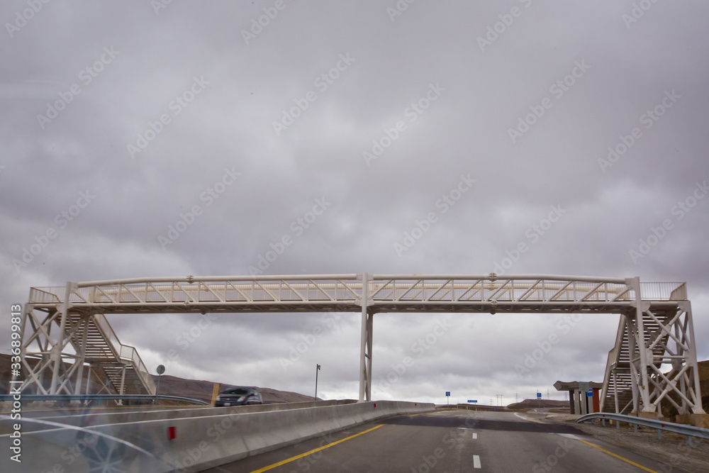 Bridges crossing people without a roof. Open road with blue clouds . The pedestrian crossing bridge . Bridges crossing people without a roof. Open road with blue clouds . The pedestrian crossing bridge .