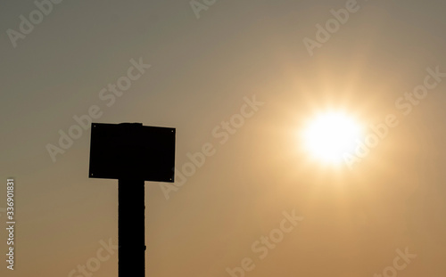 dark silhouette of a sign or signboard on a sunset background
