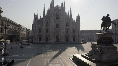 Everyday life in Milan, Italy during COVID-19 epidemic. Milano, Italian city and coronavirus lockdown. Aerial view of Piazza Duomo with cathedral seen from drone flying in sky