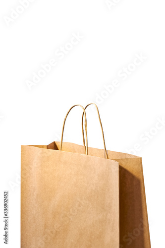 Detail of recycled brown paper shopping bag isolated on white background. Image with copy space. Vertical image. 