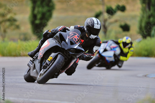 Motorcycle practice leaning into a fast corner on track