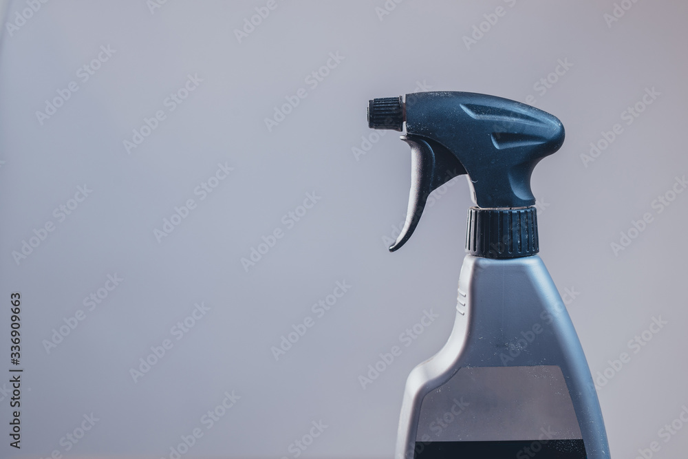 Side view of a plastic spray bottle for cleaning and operating it. Drops from bottle are being sprayed all over the place. Side view of an operational plastic spray bottle. Side view of a plastic spray bottle for cleaning and operating it. Drops from bottle are being sprayed all over the place. Side view of an operational plastic spray bottle.