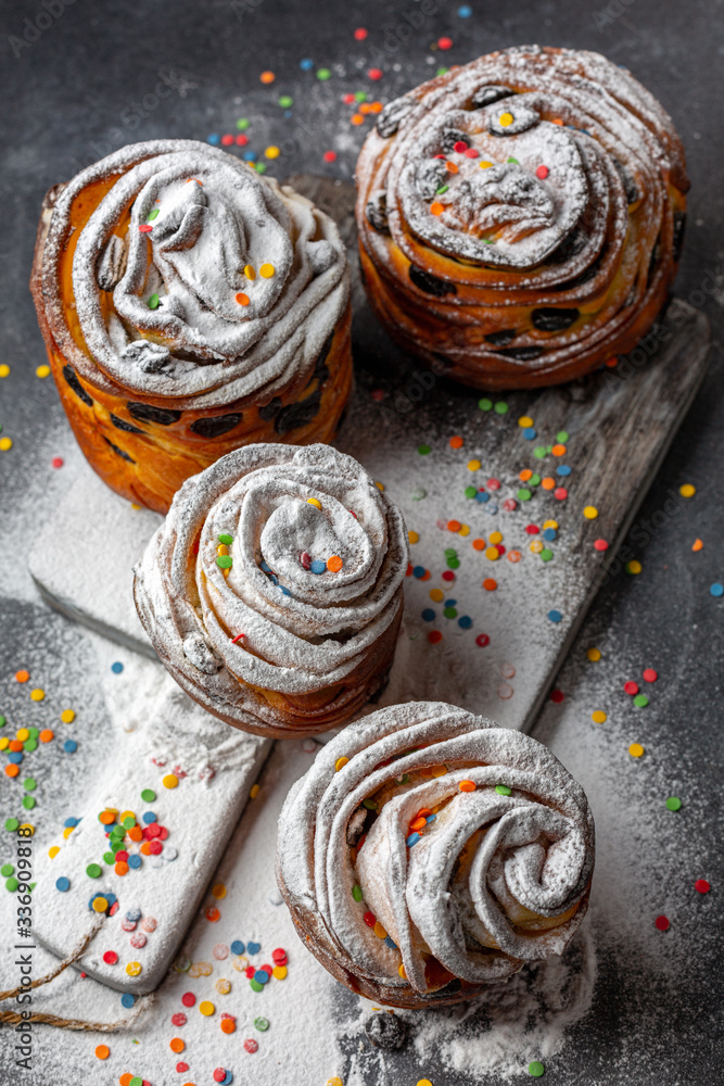 Modern pastries cruffin with powdered sugar and colored sprinkles. Modern pastries cruffin with powdered sugar and colored sprinkles.