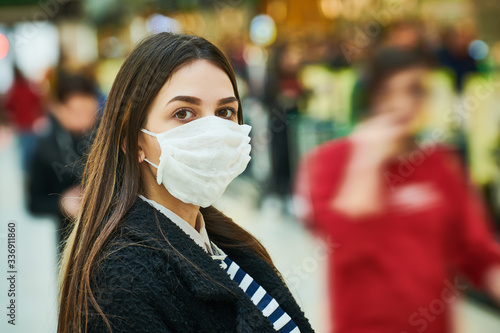 woman with face mask coughing at public place. coronavirus outbreak