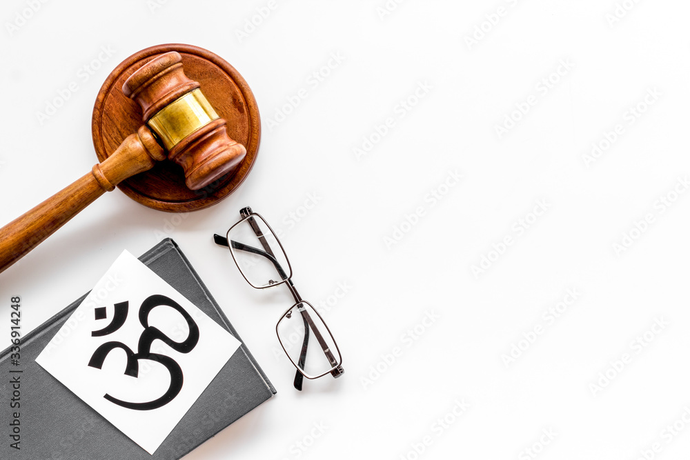 Om - Buddhist inner peace symbol - on white desk top view. Religious conflict concept. Copy space Om - Buddhist inner peace symbol - on white desk top view. Religious conflict concept. Copy space