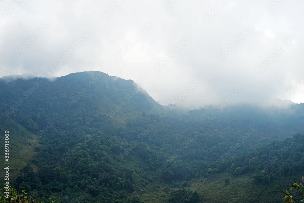 Natural landscape of green mountain range with cloudy blue sky