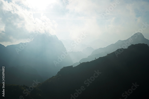 Natural landscape of green mountain range with cloudy blue sky