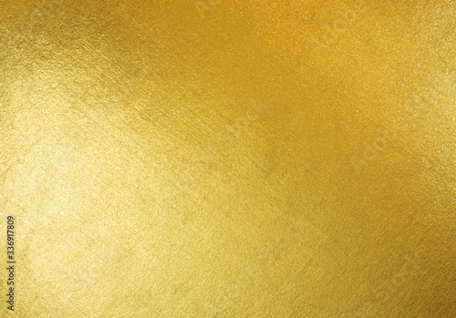 Gold texture background with yellow luxury shiny shine glitter sparkle of bright light reflection on golden surface