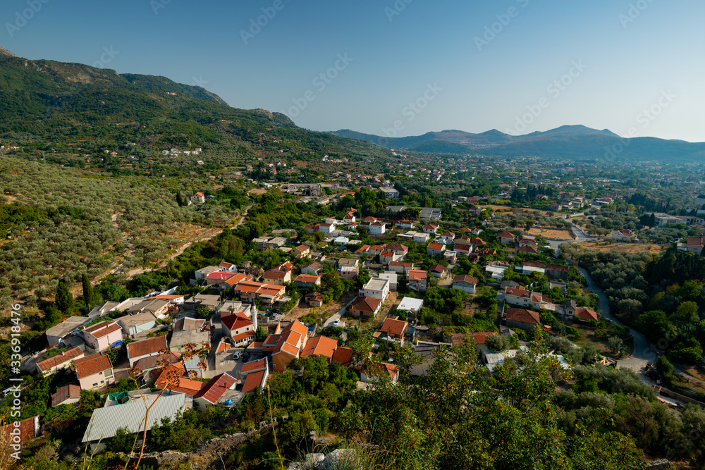 the town with houses built between the trees in the valley