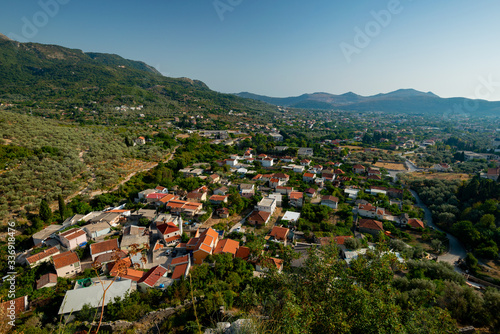 the town with houses built between the trees in the valley