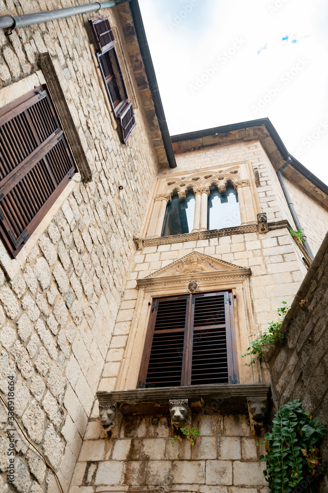 Mediterranean house with ivy and trees in the yard