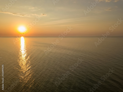 Aerial panoramic view of sunrise over sea. Nothing but sky  clouds and water. Beautiful serene scene