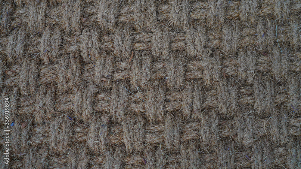Texture of weaving made of natural brown rope. fleecy geometric texture. way of weaving threads Texture of weaving made of natural brown rope. fleecy geometric texture. way of weaving threads