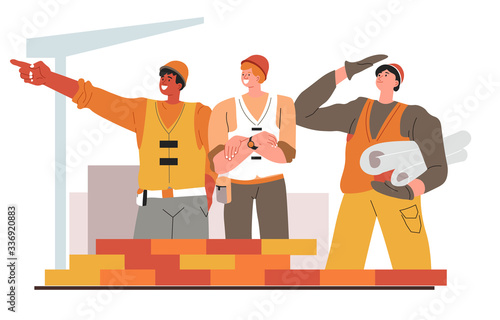 Team of builders with schemes and drafts for buildings