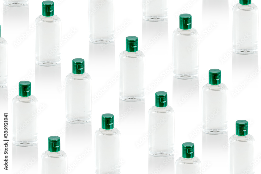 Pattern made with virus prevention medical hand sanitizer gel for hand hygiene, bottles with closed green cups. Covid-19 protection. Global pandemic concept. Pattern made with virus prevention medical hand sanitizer gel for hand hygiene, bottles with closed green cups. Covid-19 protection. Global pandemic concept.
