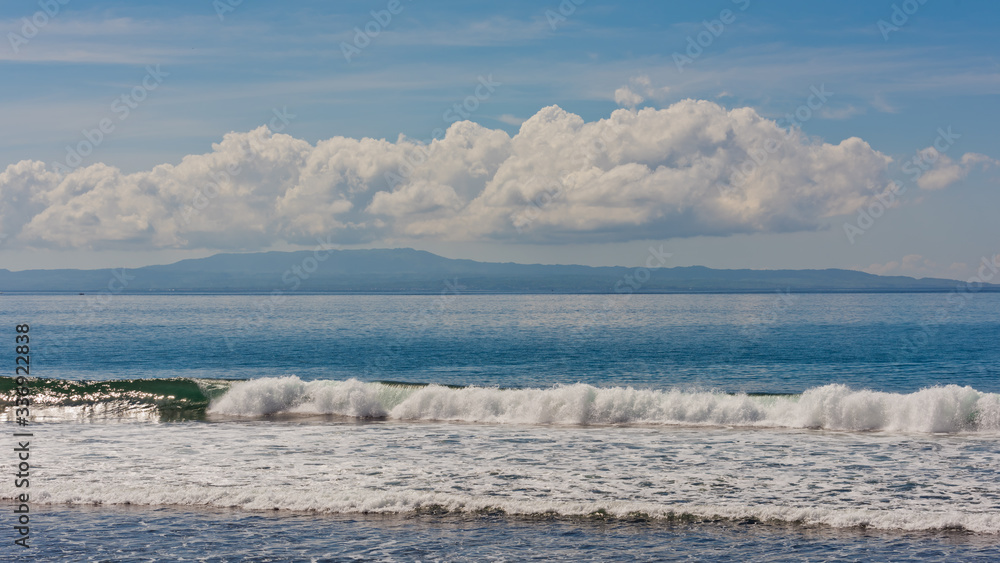 Fototapeta premium Beautiful landscape on waves of clouds and an island in the ocean.