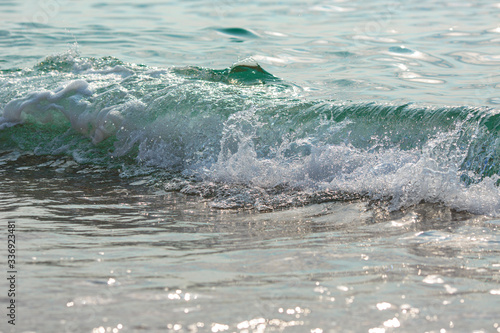 Sea tide splashes, turbulent clear water closeup