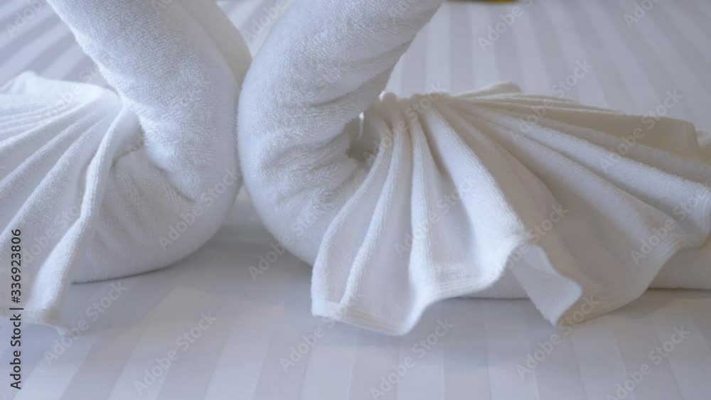 Beautiful hotel for honeymoon sweet.White towels make swan couple put on honeymoon bed look like heart shape for honeymoon lover.Towel set swan decoration bed in hotel Bedroom interior design concept. Beautiful hotel for honeymoon sweet.White towels make swan couple put on honeymoon bed look like heart shape for honeymoon lover.Towel set swan decoration bed in hotel Bedroom interior design concept.